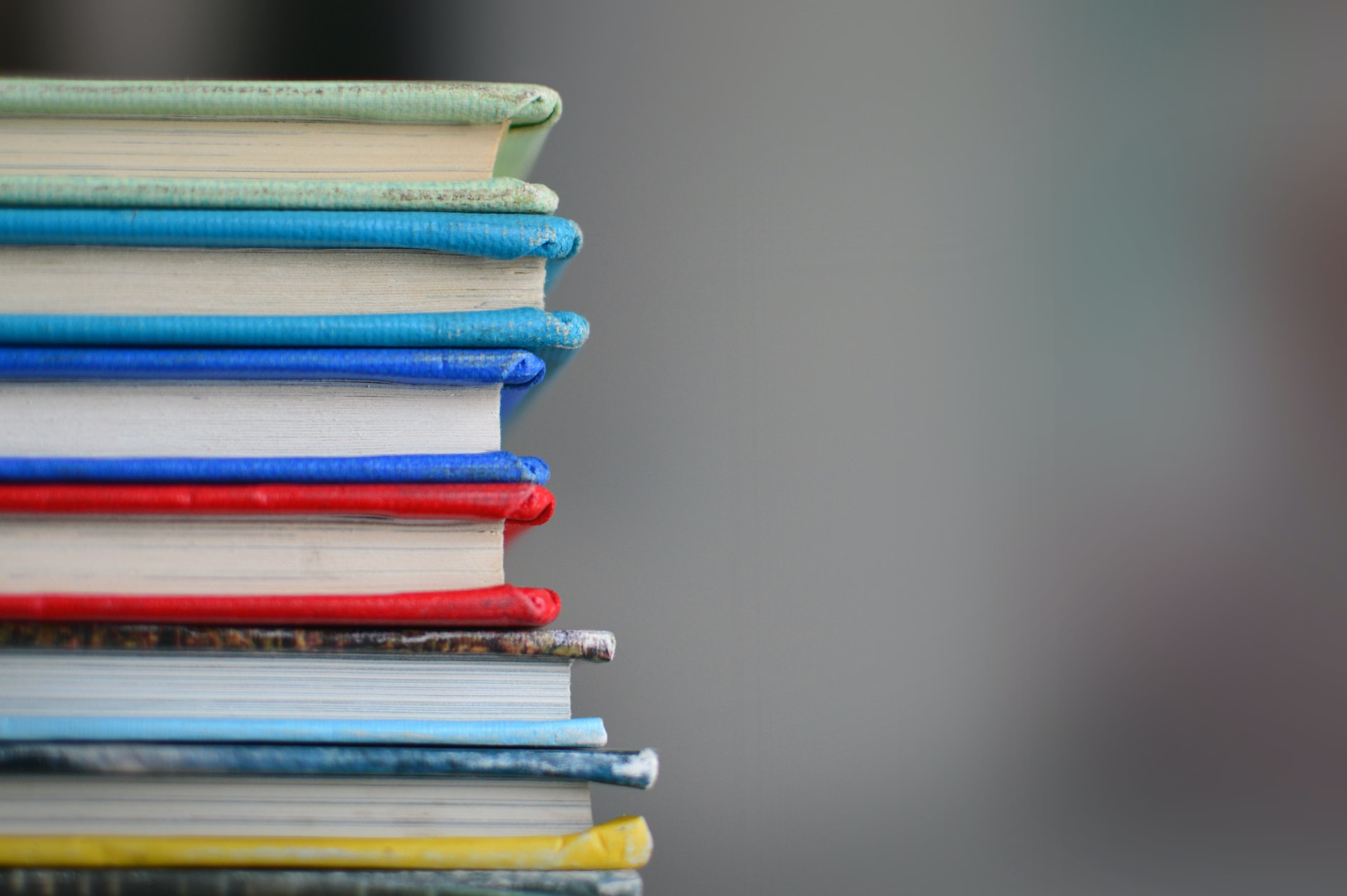 A stack of books on a blurry gray background